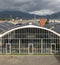 Modern building with glass facade and mountainous background